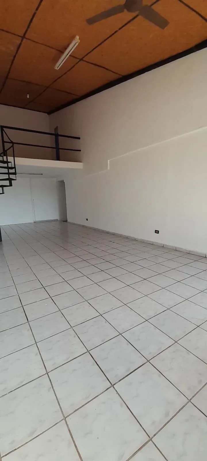 Ambiente amplio con escalera metálica