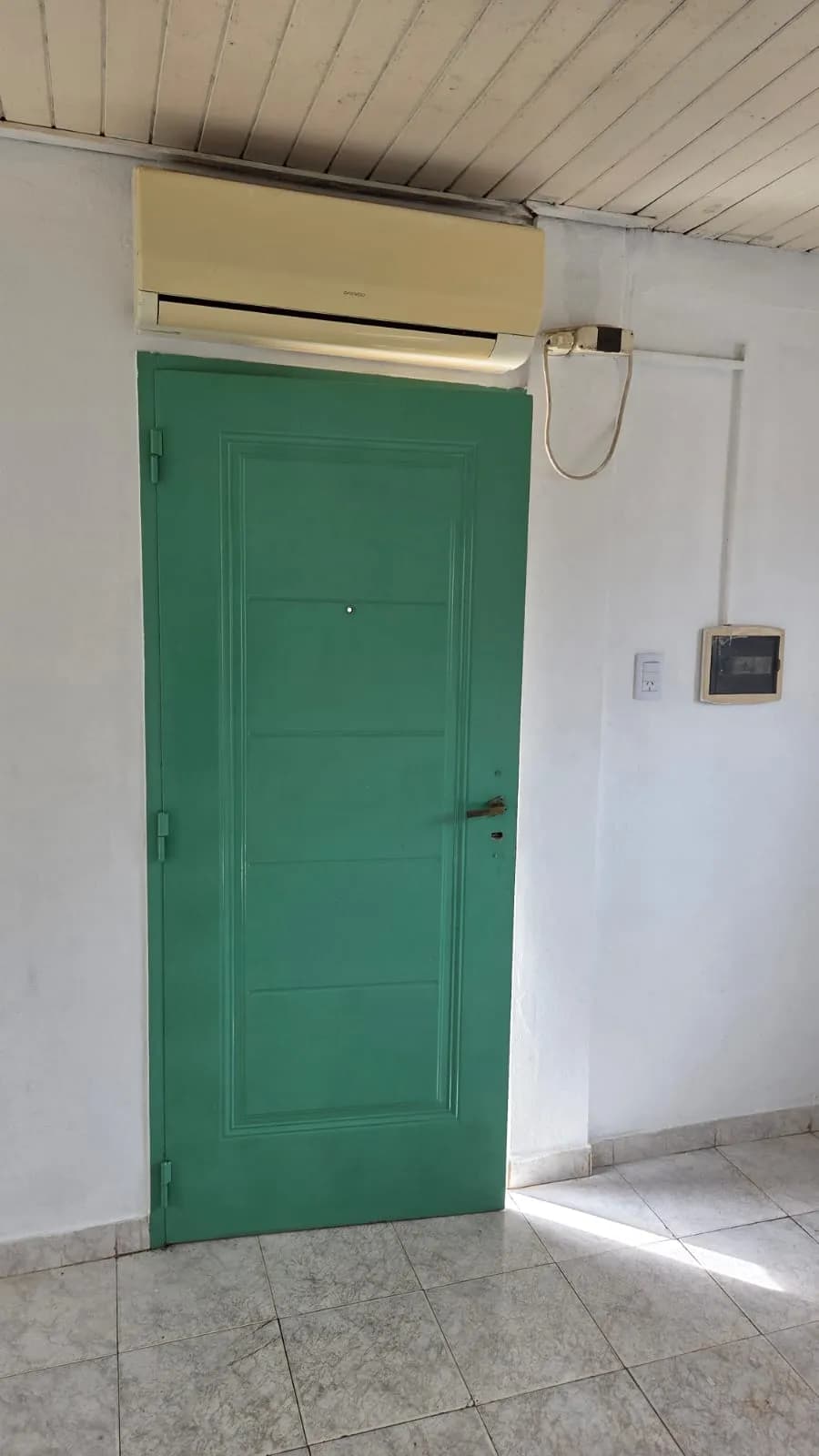 Puerta verde y aire acondicionado instalado